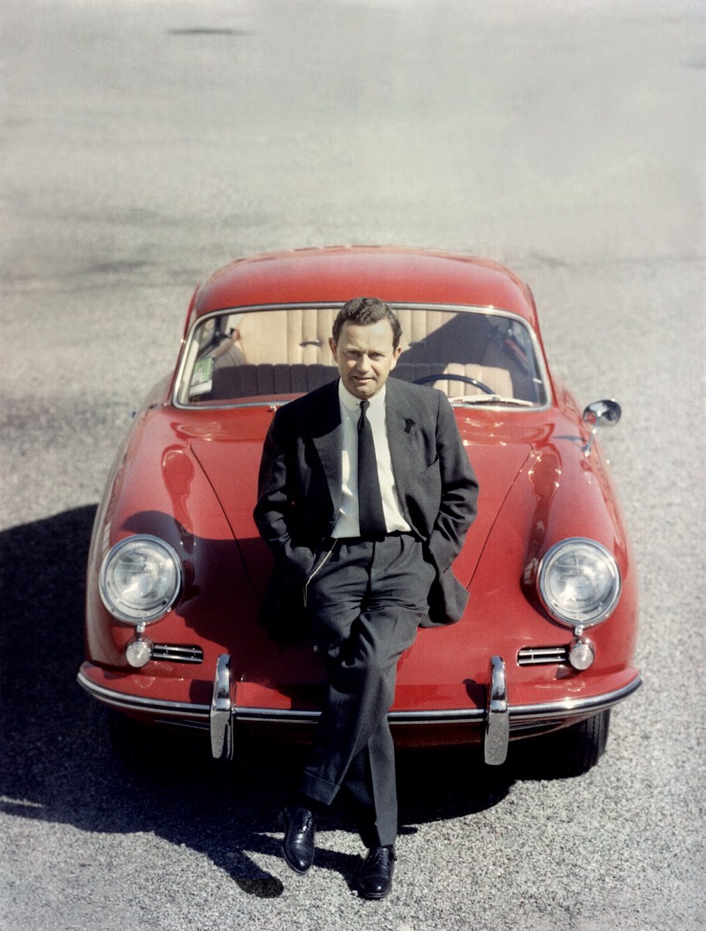 Founder Ferry Porsche sits on bonnet of red 356 B