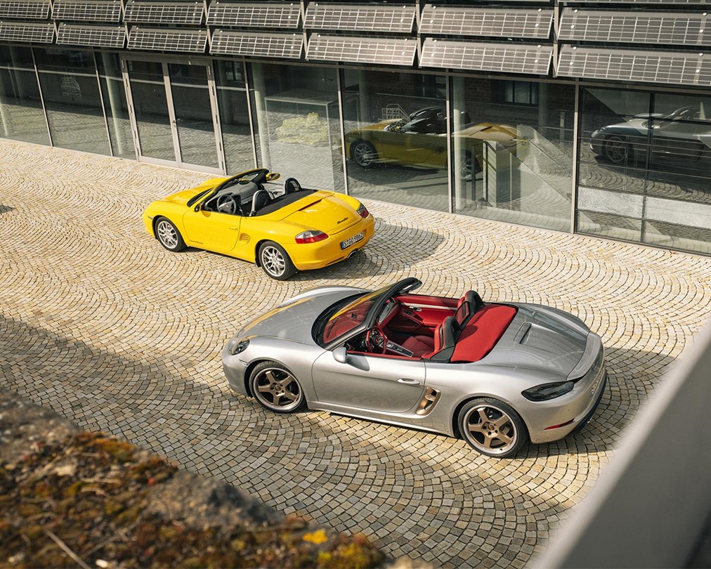 First Porsche Boxster in yellow parked beside Boxster 25 years edition