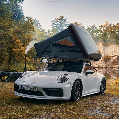 White Porsche 911 with Porsche rooftent by water