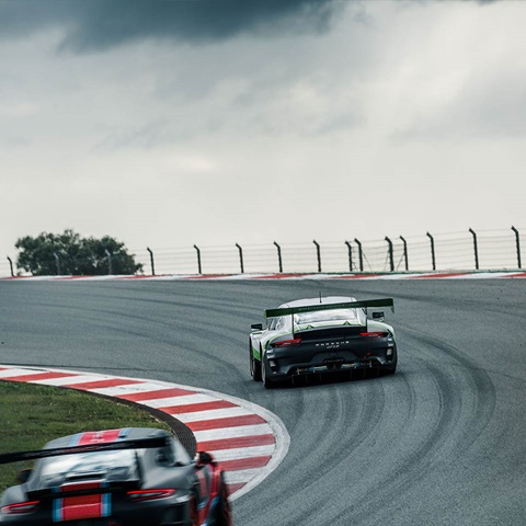 Two Porsche racecars on race track