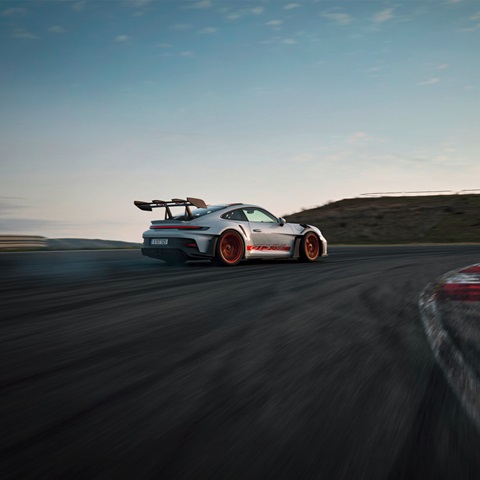 Porsche 911 GTS RS racing around bend of racetrack