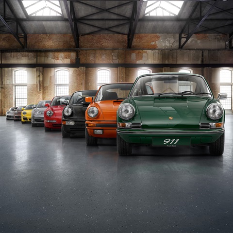 Eight generations of Porsche 911 cars lined up in warehouse