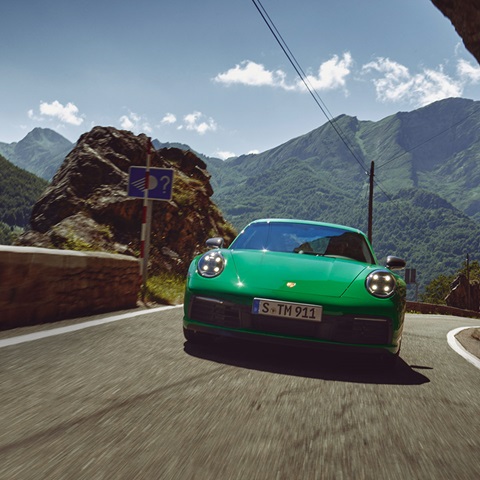 Green Porsche 911 Carrera T on mountain road