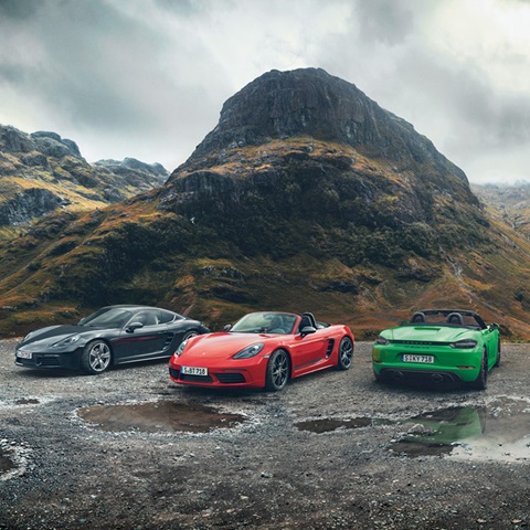 Porsche 718 range in front of rugged hills and grey sky