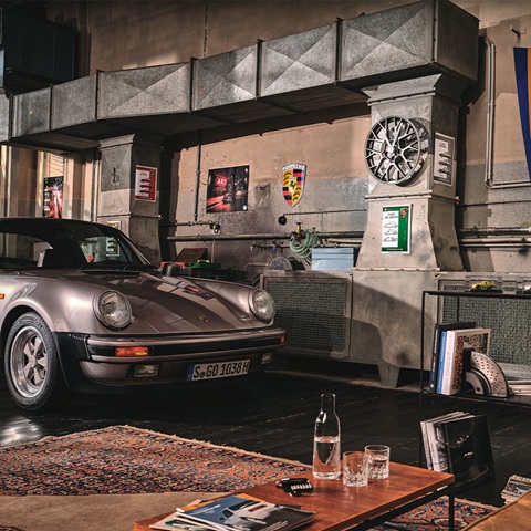 Grey 911 parked in a home workshop/garage