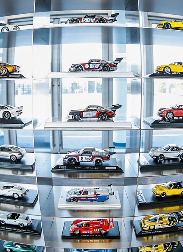 Line-up of Porsche model cars on display