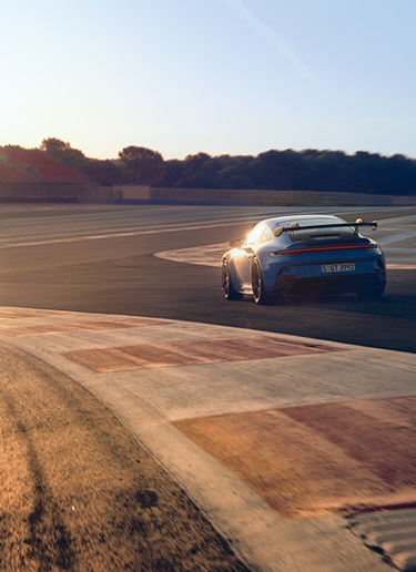 Blue 911 GT3 on Paul Ricard racetrack in evening sun