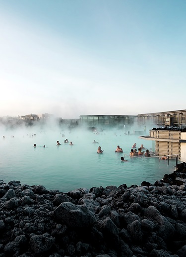 People bathing in a blue lagoon in Iceland