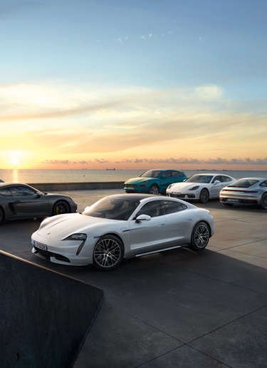 Sunset view of Porsche models next to the sea